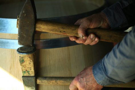 A man working on a wine barrel - close up photo